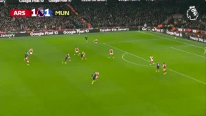 Wide broadcast shot of Arsenal vs Manchester United in a packed Emirates Stadium.